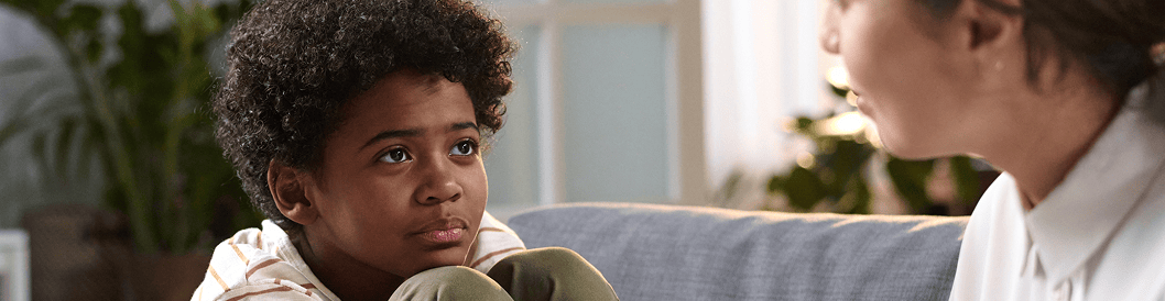 A behavior specialist having a meaningful conversation with a child.