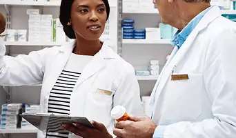 A smiling healthcare professional holding a clipboard