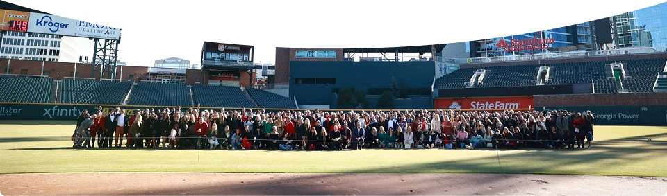 A large group of Soliant team members gathered together outdoors.