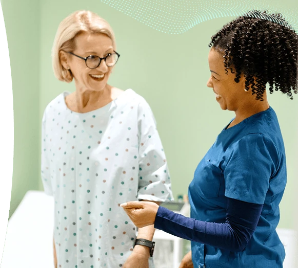 A healthcare professional smiling with a colleague.