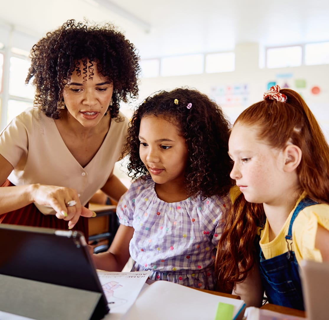 Teacher helping students in classroom