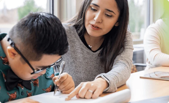 A professional helping a student with schoolwork